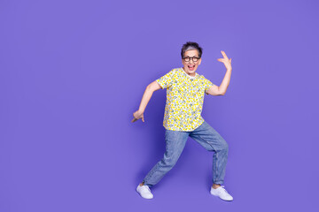 Smiling senior woman in vibrant casual outfit posing joyfully with dynamic energy against a vibrant purple background