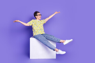 Happy elderly woman in casual spring fashion posing joyfully against violet background