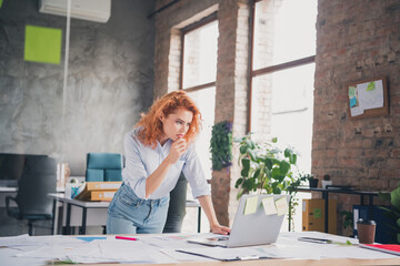 Photo of successful young business woman use laptop ponder modern loft interior office indoors