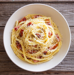 Pasta bucatini carbonara with cheese and pancetta. Italian food.
