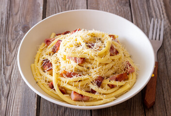 Pasta bucatini carbonara with cheese and pancetta. Italian food.