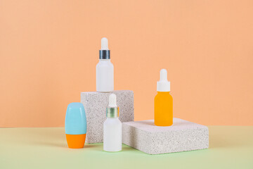 Plastic white tube for cream or lotion. Skin care or sunscreen cosmetic with stylish props on cream background.