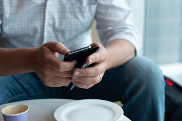 man using phone at airport