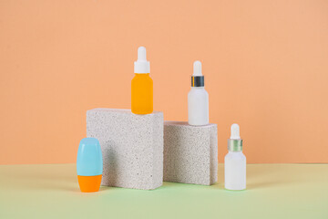 Plastic white tube for cream or lotion. Skin care or sunscreen cosmetic with stylish props on cream background.