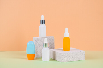 Plastic white tube for cream or lotion. Skin care or sunscreen cosmetic with stylish props on cream background.