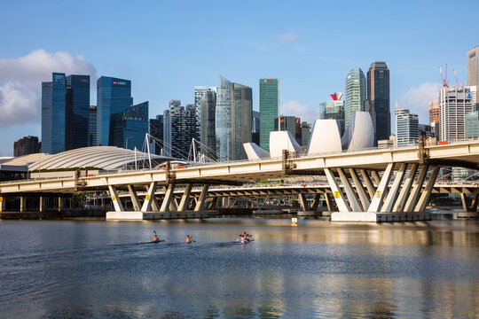 People kayaking in front of downtown skyline, Marina Bay, Singapore city