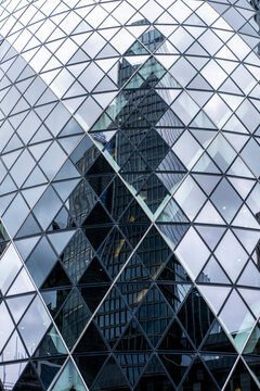 Abstract reflections of skyscrapers on a glass facade, geometric urban architecture.