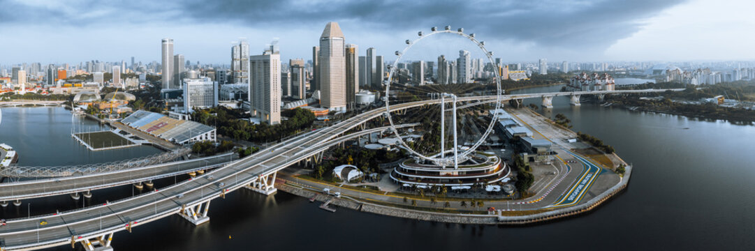 Aerial panoramic view of ferris wheel and Marina Bay, Singapore city