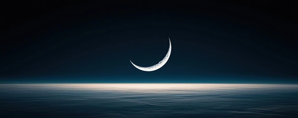 Dark sky concept. A serene crescent moon glowing above a dark horizon, creating a tranquil night ambiance.