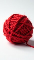 Intricate red woolen ball, tightly wound threads, white background, warm, wool