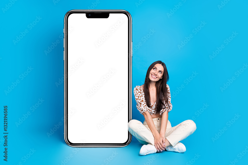 Poster full size photo of pretty young woman look empty space smart phone display isolated on blue color ba