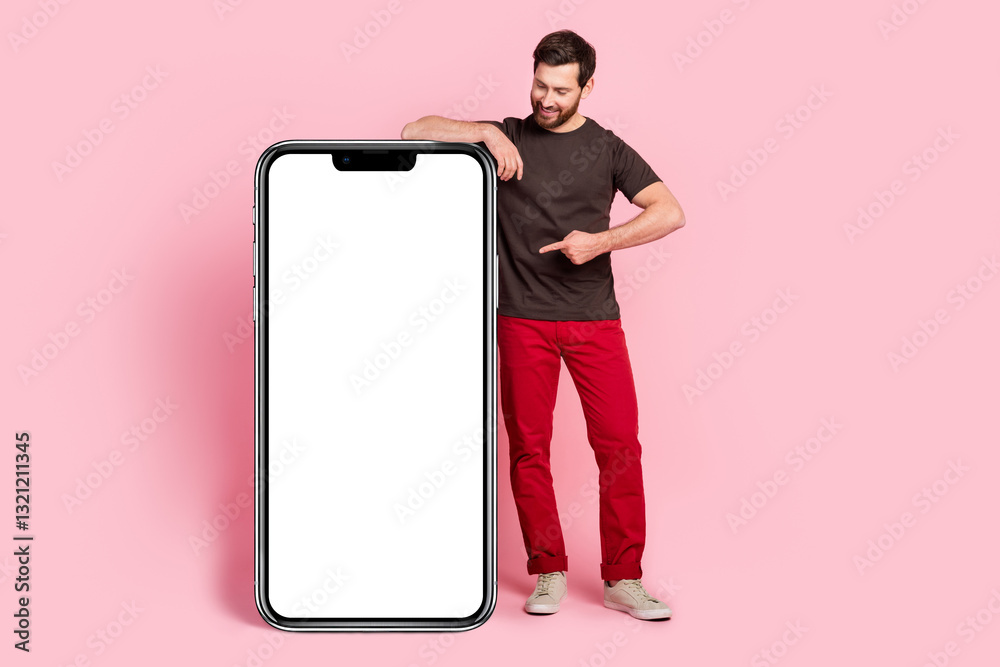 Poster full size photo of good mood man dressed brown t-shirt indicating look at smartphone display empty s