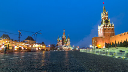 Red Square in winter day to night timelapse. Moscow Kremlin with Spasskaya tower and Cathedral of St. Basil, Russia