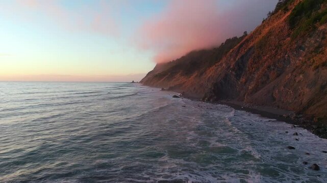Northern California waves crashing bluffs cliffside mountain rocky rugged remote coastline aerial drone vibrant sunset USAL Beach Campground Sinkyone Wilderness surf swell forward motion