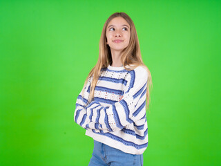 beautiful teen girl wearing striped sweater arms crossed look empty space billboard
