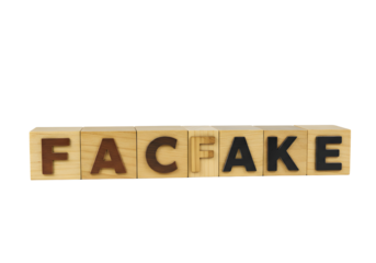 Wooden Blocks Spelling 'FACFAKE' on Transparent Background Symbolizing Deception