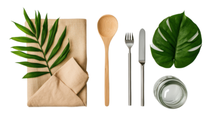 Tropical palm leaves and wooden kitchen utensils like spoon fork knife on a minimalist table setting with kraft paper background  Flat lay composition with green foliage and dining props