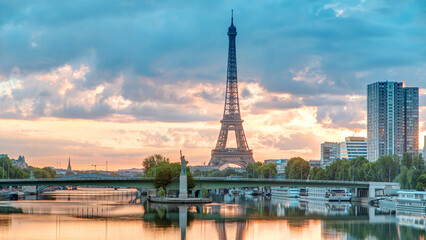 Eiffel Tower sunrise timelapse with boats on Seine river and in Paris, France.