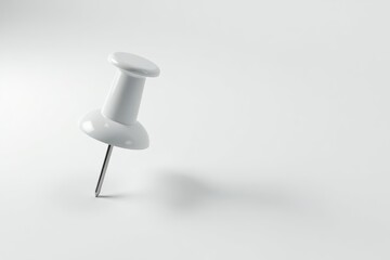 White pushpin, subtle shadow on white background, concept, refined