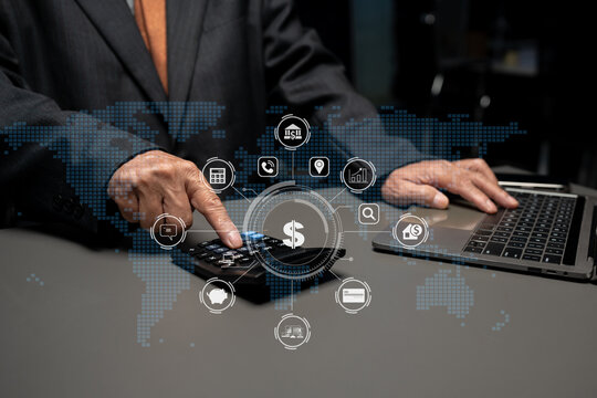 Male businessman hand using calculator and writing make note with calculate about cost.