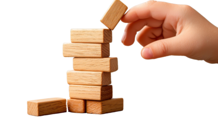 Carefully stacked wooden blocks arranged in a tower formation symbolize the process of building growing and achieving goals through strategic planning problem solving and determined effort