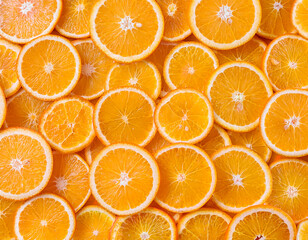 Flat lay of juicy orange slices forming a seamless vibrant citrus background  
