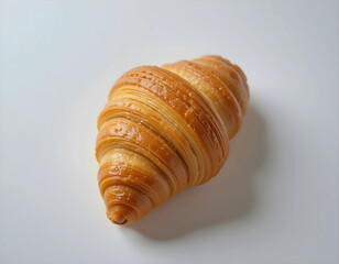 A beautifully golden-brown croissant with delicate, flaky layers and a glossy, buttery finish. The rich texture and crisp exterior make it an inviting and delicious pastry.