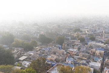 crowded misty city view from mountain top at morning