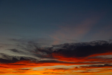 Fototapeta premium Dramatic orange clouds and sunrays at sunset