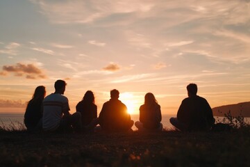 Friends gather at sunset overlooking the ocean while enjoying a peaceful evening together