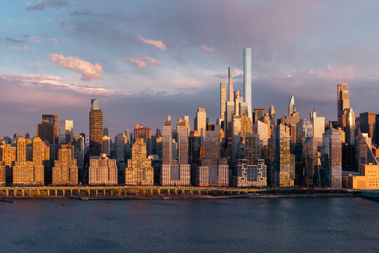 New York City aerial view of Upper West Side skyscrapers at sunset. Hudson River Park with Manhattan skyline