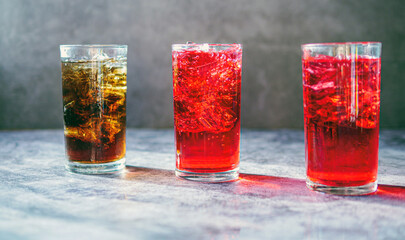 A lot of Soft drinks in colorful and flavorful glasses on the table,Glasses with sweet drinks with ice cubesv