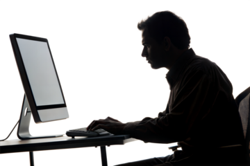 Silhouette of a man working on computer
