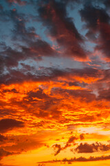 Fototapeta premium Sunset background vertical photo. Dramatic orange clouds
