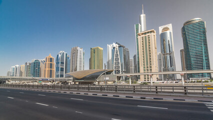 Naklejka premium View of Jumeirah lakes towers skyscrapers and metro sration timelapse hyperlapse with traffic on sheikh zayed road.