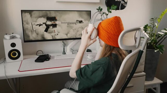 Dedicated gamer gently places high-quality headset for seamless sound isolation. Clean desk setup, immersive lighting, and top-tier gaming peripherals ensure ultimate gaming experience.