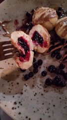 Potato dumplings filled with blueberries and topped with melted butter in slovakia strbske pleso, high tatras