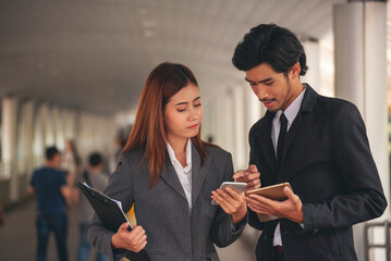 Group of Asian business people diversity talking meeting outside office. Multiethnic teamwork collaboration team meeting. Business people shaking hands together diversity multiethnic Business partner