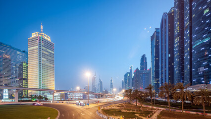 Traffic on intersection and bridge at the Sheikh Zayed Road day to night timelapse