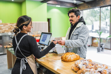 Customer paying with contactless card at bakery counter