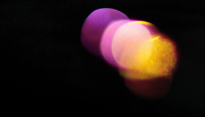 Color light overlay. Defocused yellow-pink radiance soft texture on dark black abstract empty space background. Light in the galaxy with gradient colors on black background.