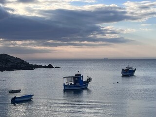 Naklejka premium fishing boats at sunset Porto ferro, Alghero, Italy.