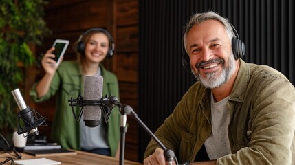 Mature caucasian male podcaster with female co-host in studio setting.
