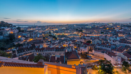 Obraz premium Lisbon panorama after sunset aerial view of city centre with red roofs at autumn day to night timelapse, Portugal