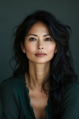 Fototapeta premium A woman with long black hair and a green sweater