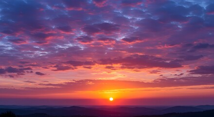 Fototapeta premium Dramatic and colorful sunset over the mountain range with vivid sky