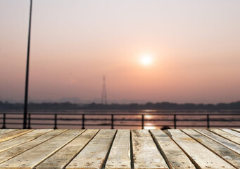 Wooden table top on the beach or sea.Party on the beach  sunset time concept.For montage product display or design key visual layout.View of copy space.