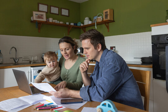 Family Budgeting Together with Laptop and Papers