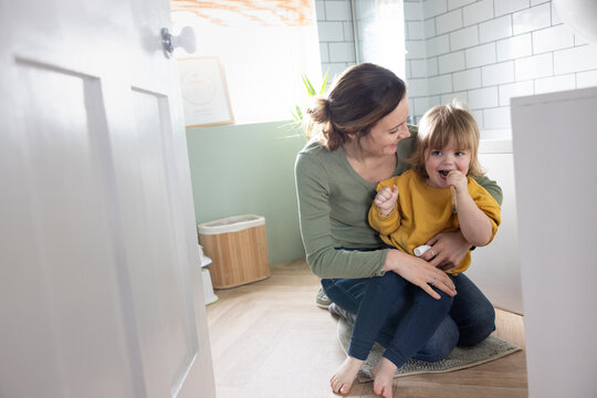 Mother and child enjoying playful tooth brushing