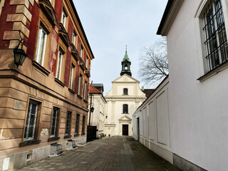 Historic architecture in old town Warsaw Poland featuring a charming Church of St. Benon